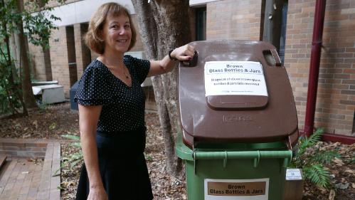 A staff member who is an environmental champion with bottle recycling