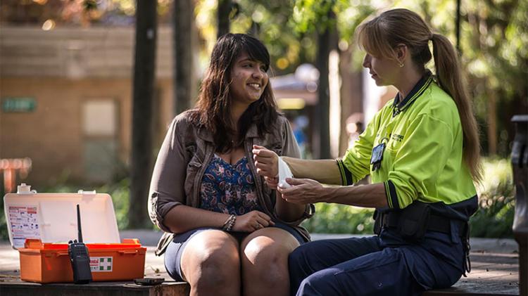 A student receiving first aid assistance from UOW Security