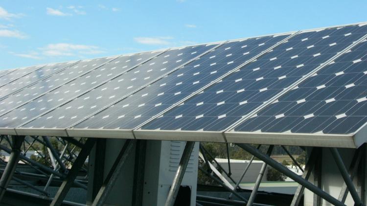 Solar panels on roof under blue sky
