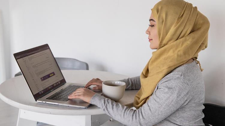 Muslim woman in Hajib at computer