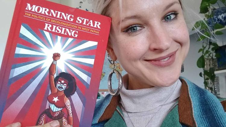 Cammi Webb-Gannon holding her book, Morning Star Rising