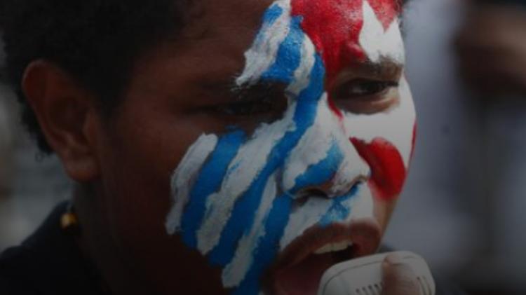 West Papua native with traditional face paint