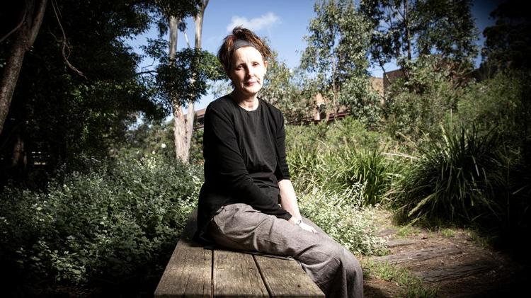 Catherine McKinnon sitting on bench at Wollongong Campus
