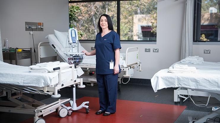 A UOW nursing alumni stands in an Illawarra Health hospital