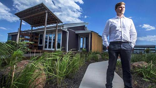 Lloyd Nicol stands in front of the winning Solar Decathlon sustainble house