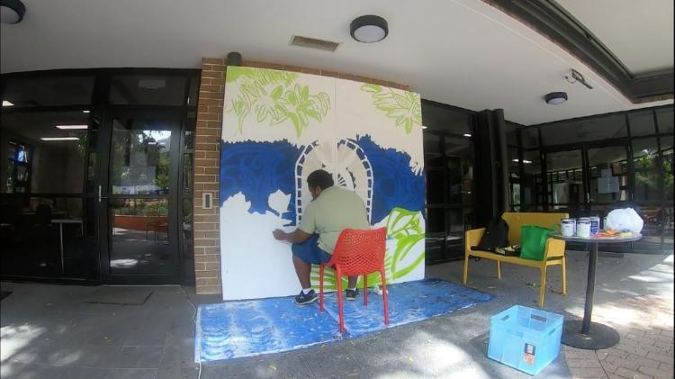 artwork being painted in WIC courtyard