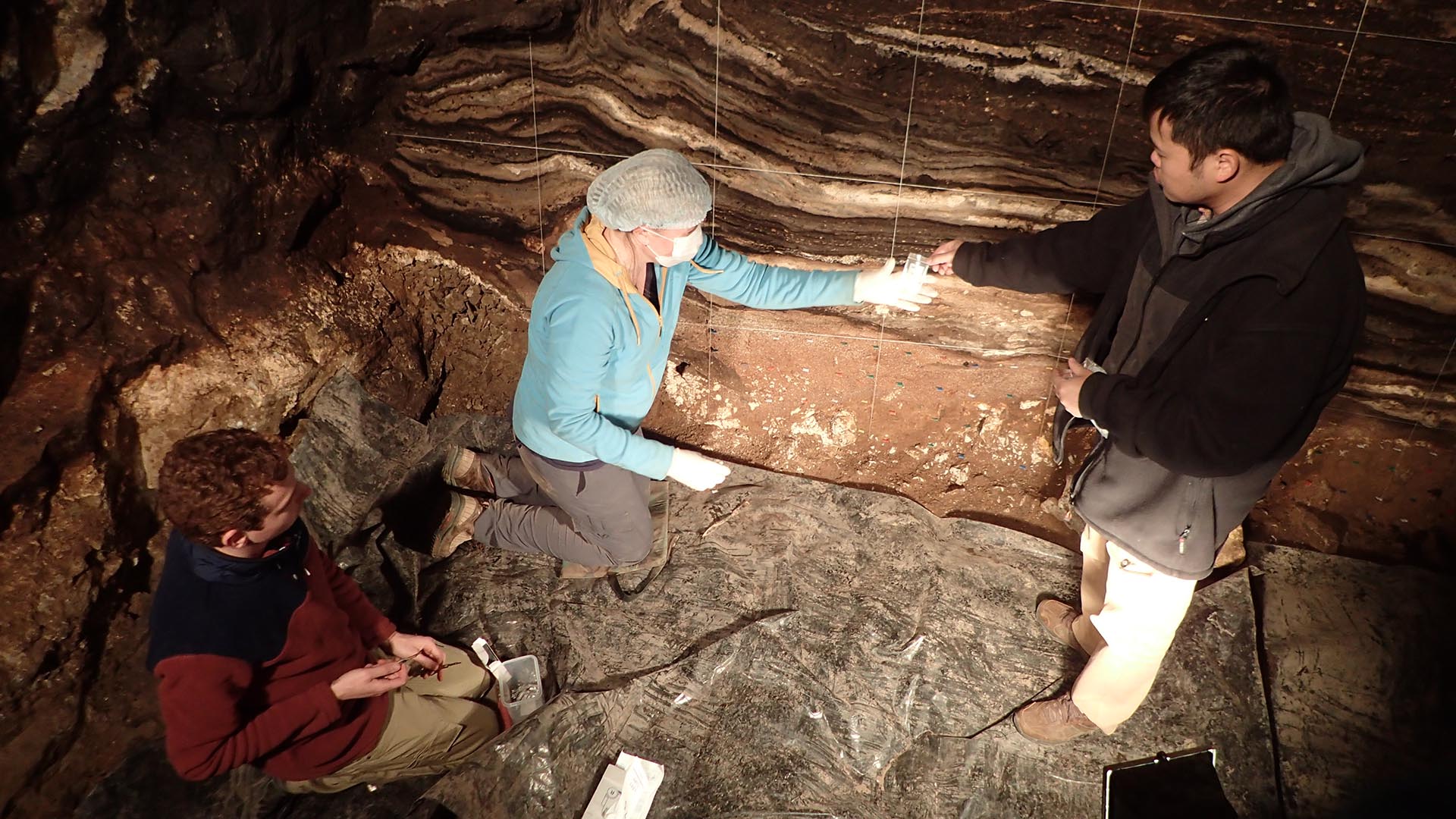 Kieran O’Gorman, Zenobia Jacobs and Bo Li collect sediment DNA samples from extensively phosphatized deposits in Denisova Cave's South Chamber. Credit: Richard ‘Bert’ Roberts, University of Wollongong