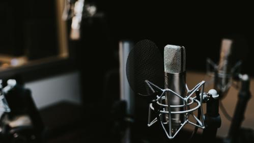 A single radio microphone against a dark background