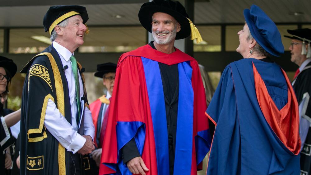 Craig Foster, centre, with Deputy Chancellor Robert Ryan (left) and Professor Grace McCarthy in the graduation procession. Photo: Andy Zakeli