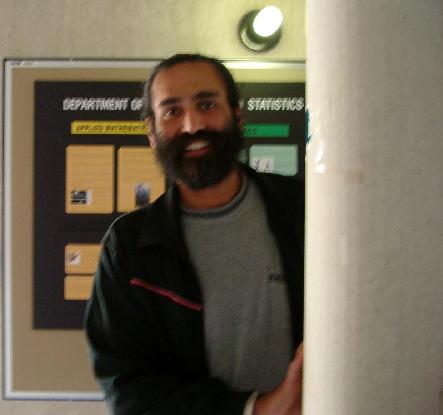Harvi Sidhu hiding behind a pillar in the School of Mathematics
      and Statistics.