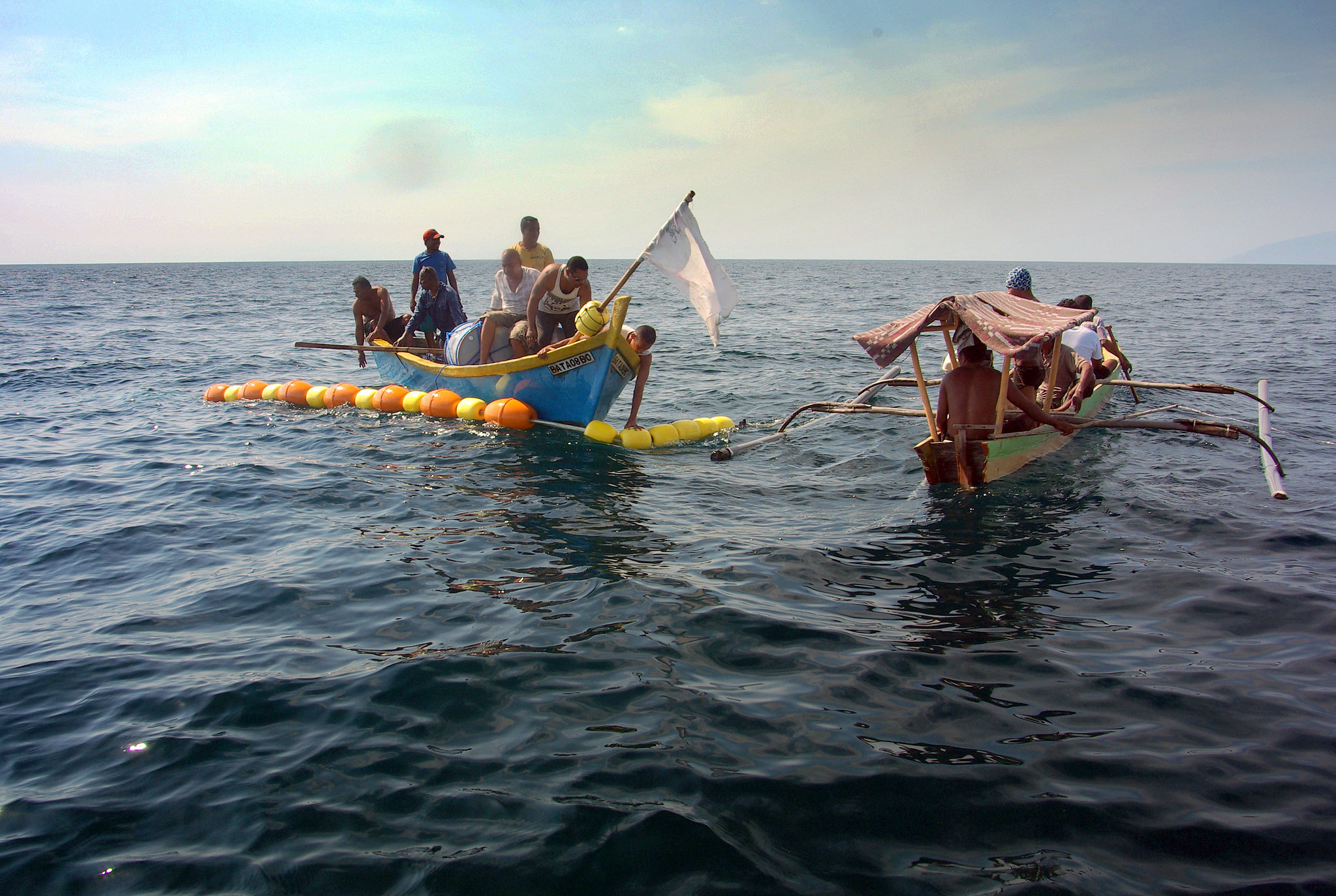 Two boats on the sea in Timor-Leste use fishing nets