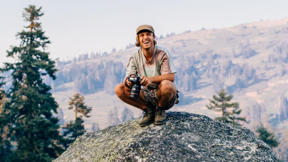 Keegan Taccori on a mountain with his camera
