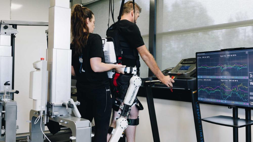 Maryanne Harris helping husband Daniel on Robofit technology