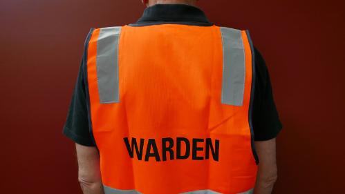 A staff member wearing Building warden High visibility vest