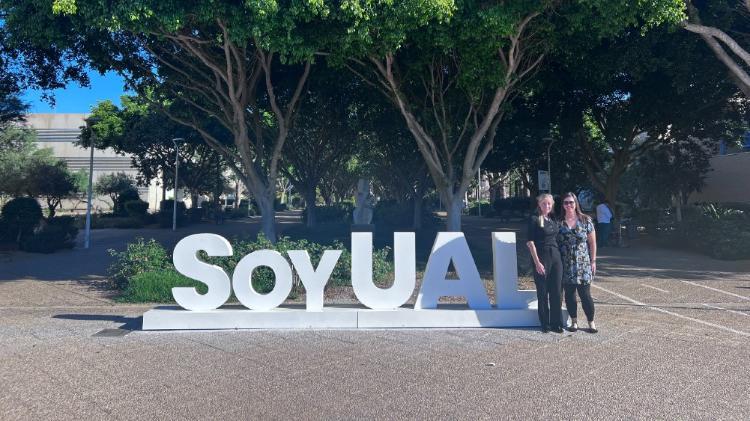 Tina Prodromou and Erin Snape standing near white large 3D letters SoyUAL in France
