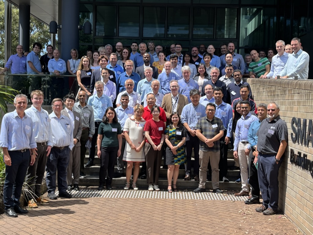 Steel Research Hub Symposium attendees stand on the steps on the SMART building