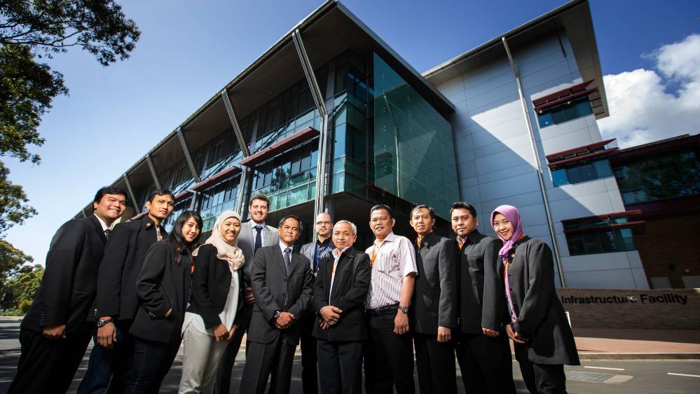 Image of the UOW SMART PetaJakarta project team outside the SMART building at UOW campus
