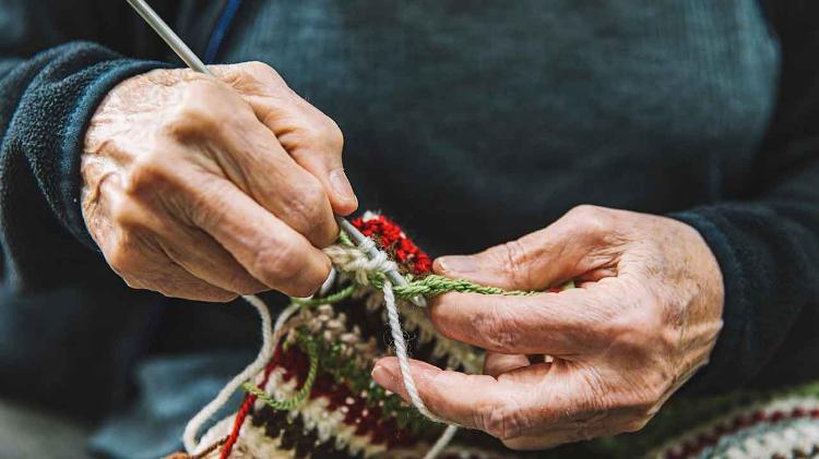 Elderly person crocheting