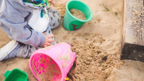 Photo of preschool aged child playing in sandpit
