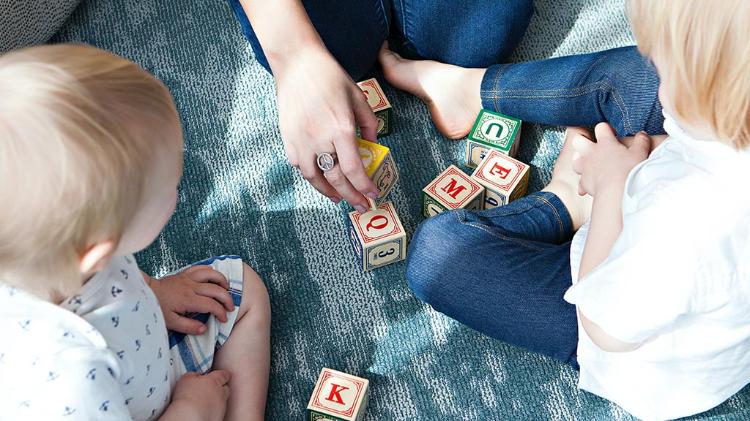 Birdseye view of an adult playing with blocks with children