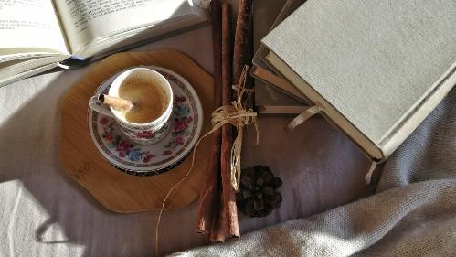 Photo representing self care - cup of tea, books and smelly sticks