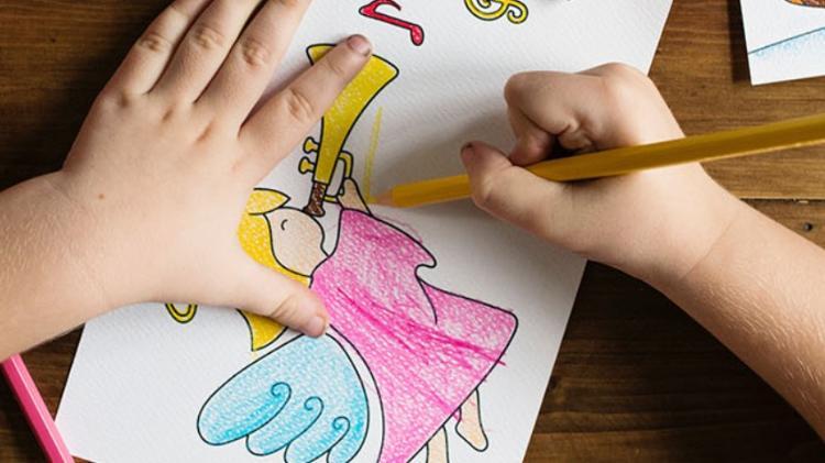 Birdseye view of child colouring a fairy