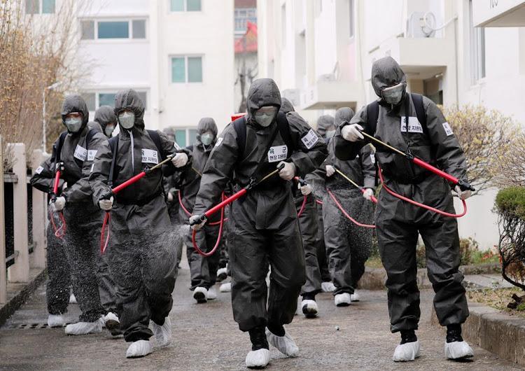 A group of people walking in protective clothing