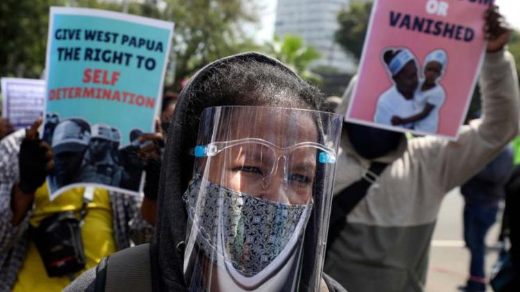 Woman wearing protective face mask in protest for West Papua