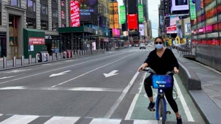 Sandra Siagian on a bike in a empty New York city street during COVID 19 pandemic
