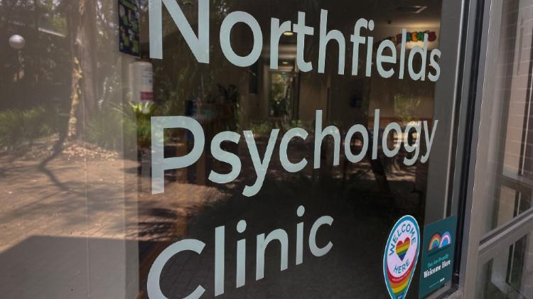 Glass entrance with Northfields Psychology Clinic written in write letters