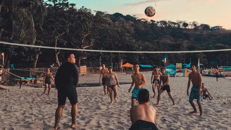 Group of people playing volley ball on beach