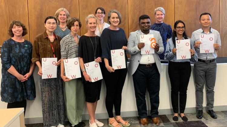 Group of people standing with awards