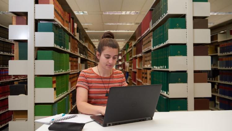 Student at a laptop in the UOW Law Collection