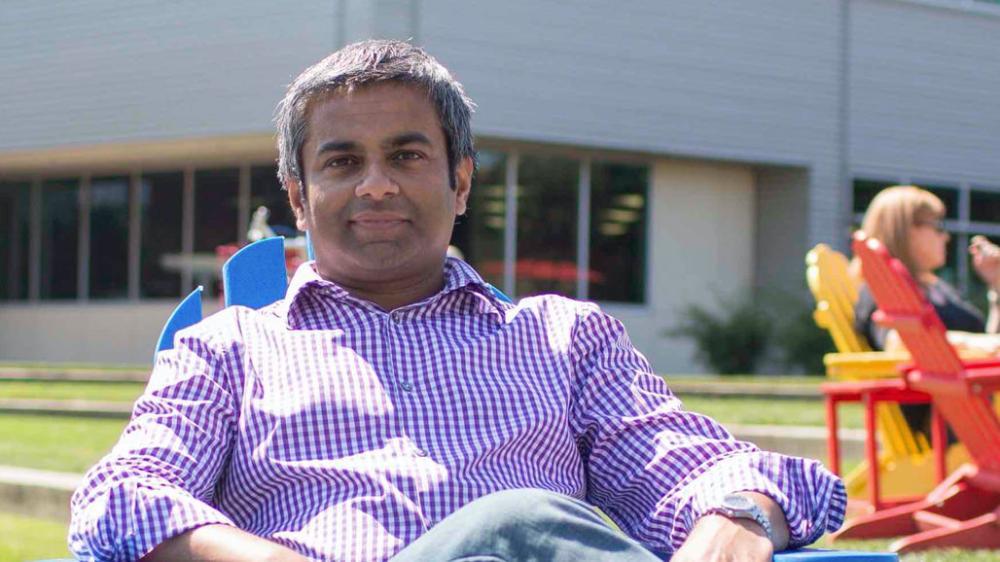 Sunil Chandra sitting on a lawn chair outside at Google headquarters