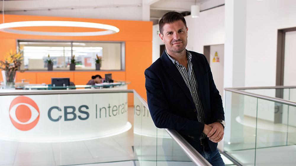 Luke Fredberg standing in CBS international studio