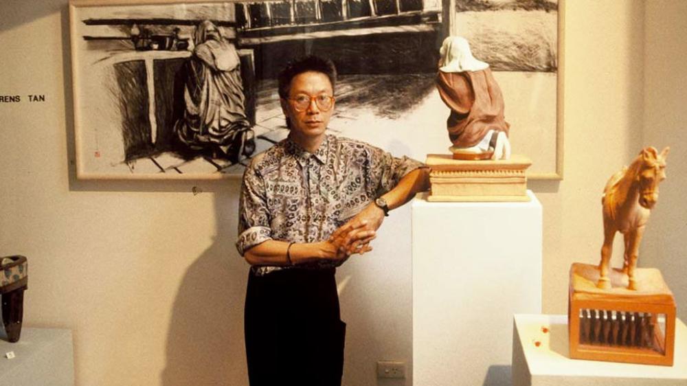 Dr Laurens Tan standing with artwork