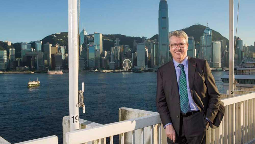 Vice-Chancellor Professor Paul Wellings standing on the shore of Victoria harbour in Hong Kong