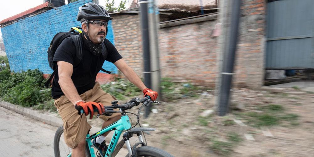 Dr Dixit riding a bike