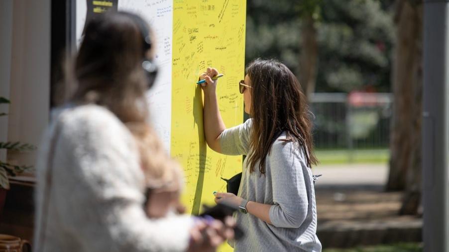 Lonely together sign being written on