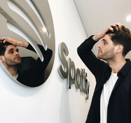Nicholas staring into Spotify shaped mirror