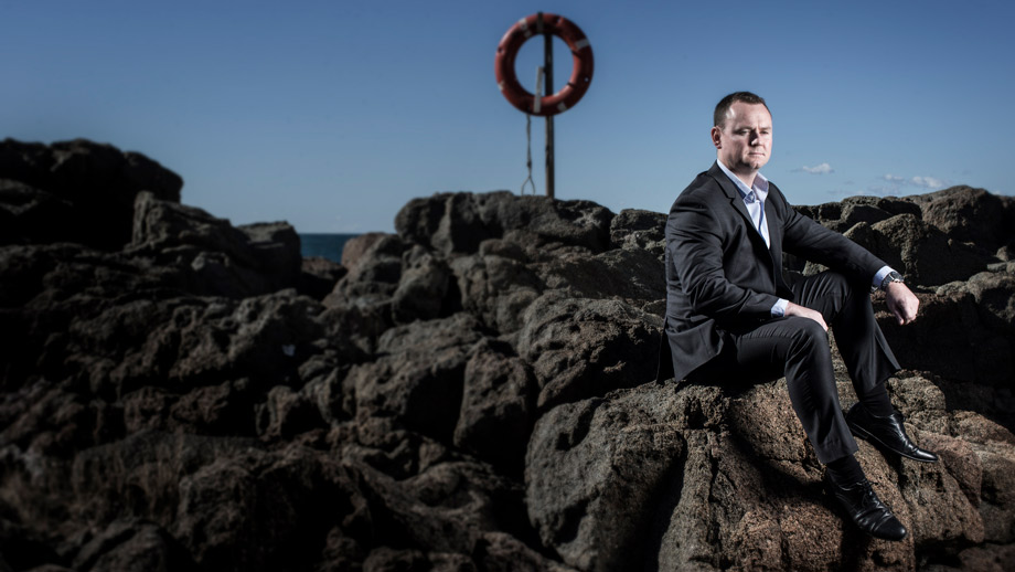 Mick Bainbridge sitting on rocks at Port Kembla