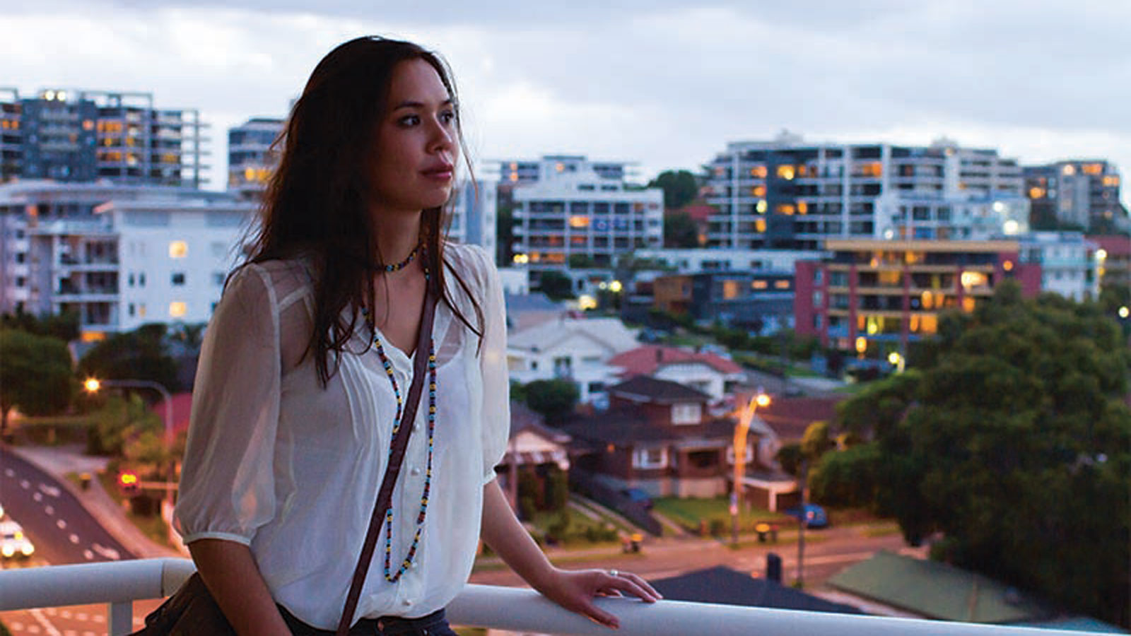 Girl on balcony with Wollongong city view
