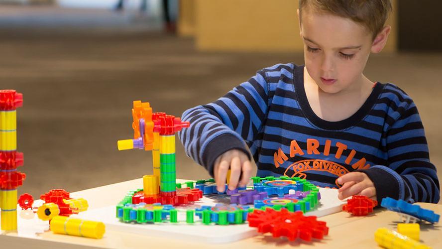 A preschooler plays with building blocks.