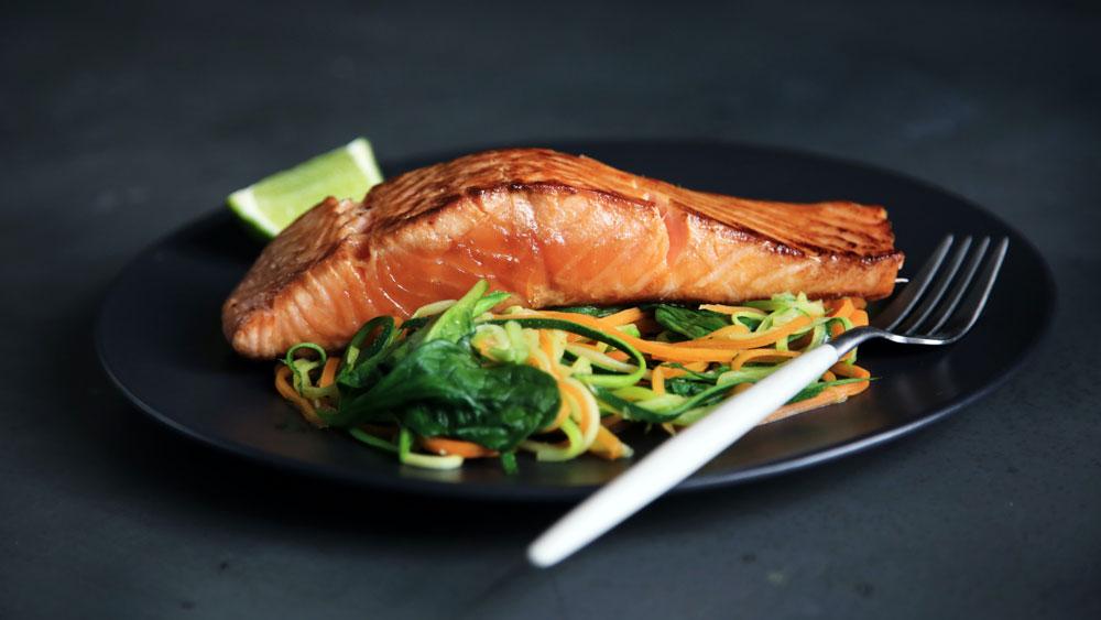 A salmon and salad dish on a plate.