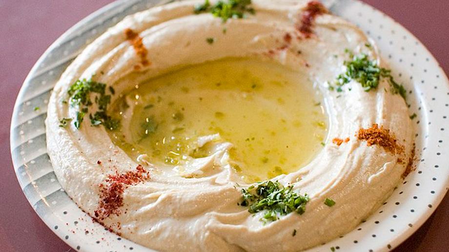 Hummus and olive oil in a bowl.