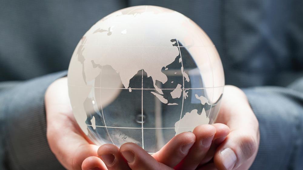 A mini globe in someone's hands