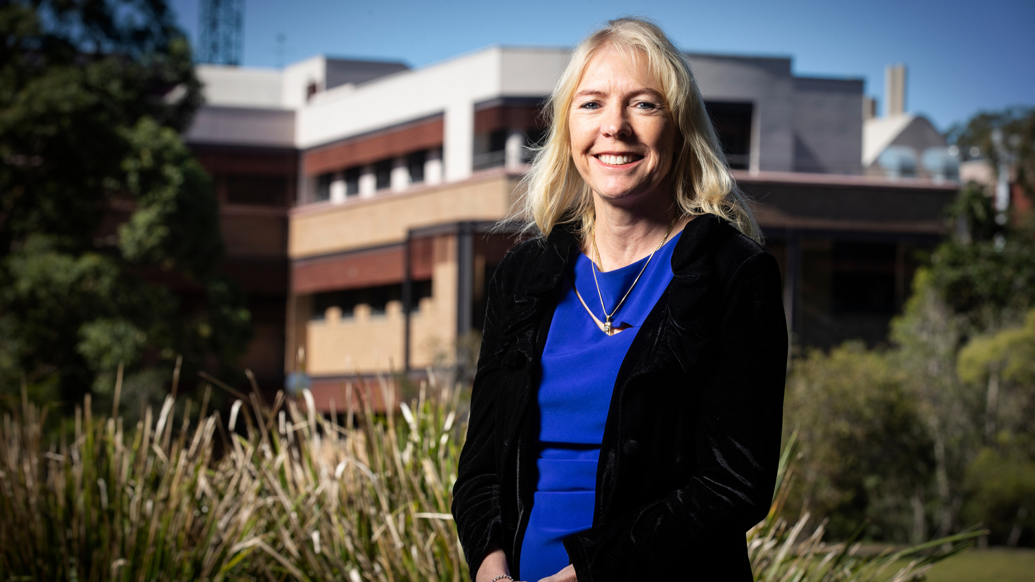 Karen Charlton stand in front of a building on campus at UOW Wollongong.