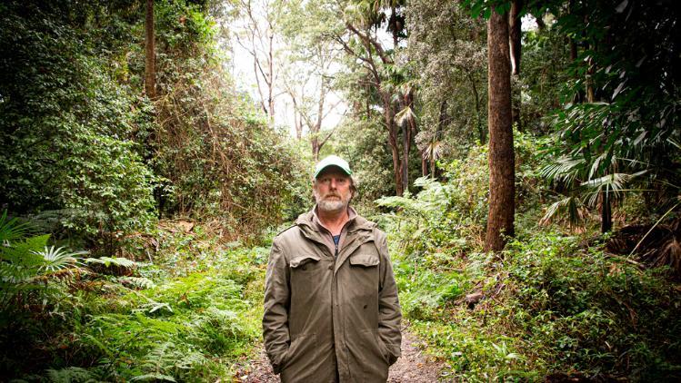 UOW Photographer Paul Jones stands on the Wodi Wodi walking track.