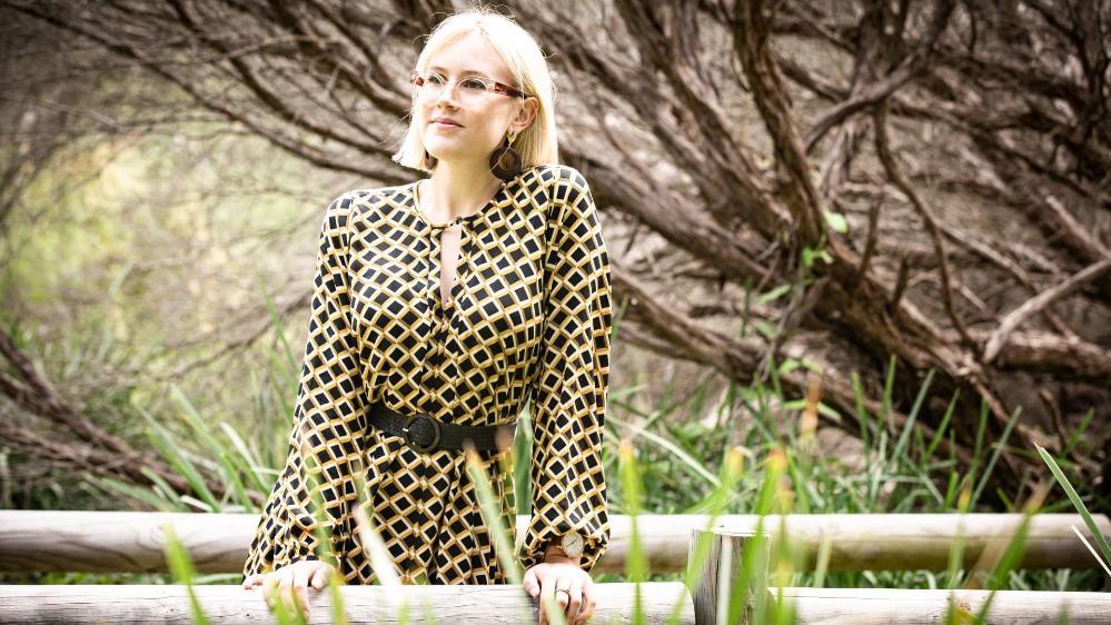 UOW student Susie Alderman, pictured under a tree at the beach. Photo: Paul Jones