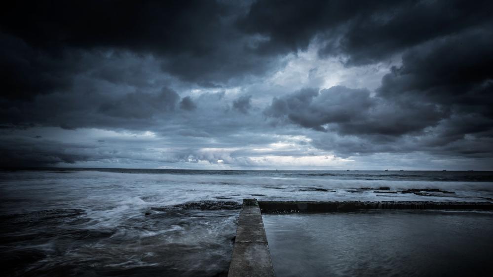 An image of a rockpool with a cloudy sky. Photo: Paul Jones